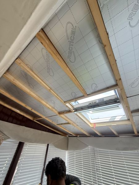 Inside the conservatory: insulation boards between rafters and the roof window