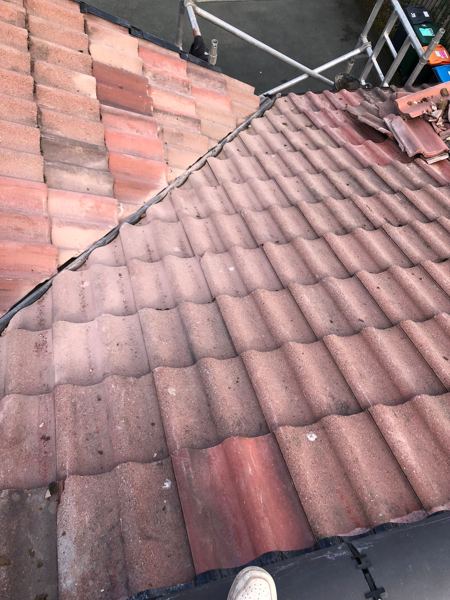 Tiles relaid and cut along the valley, with the scaffold above