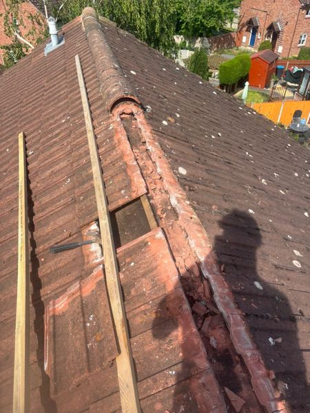 Part of the ridge stripped, with battens laid on the slope ready