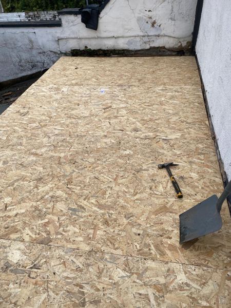 New OSB deck complete between the white-painted walls