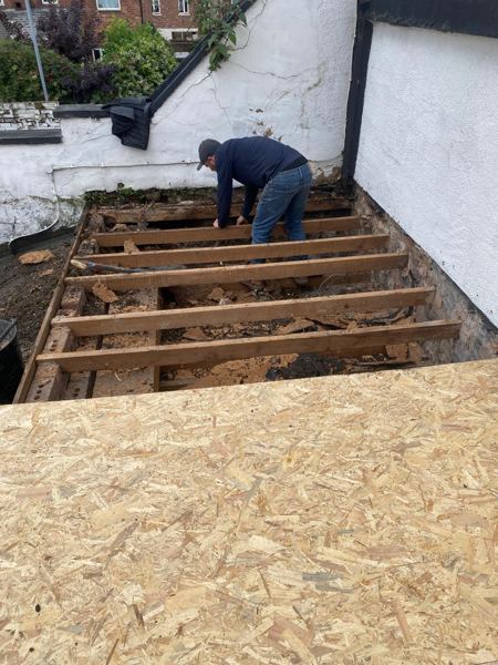 Old decking cleared, joists exposed, new OSB laid on the first section
