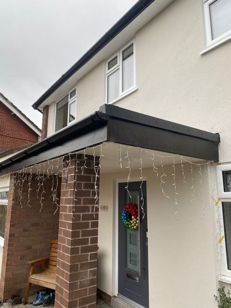Finished canopy over the front porch with a black fascia line