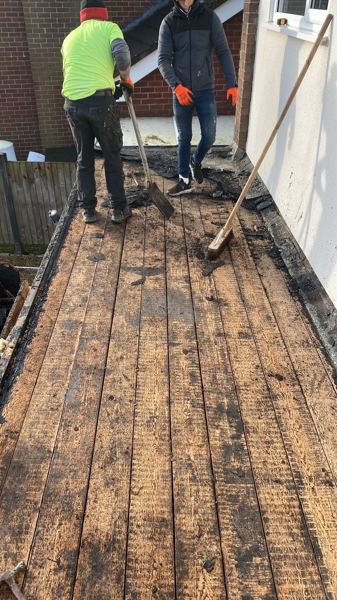 Old covering cleared back to the timber plank deck