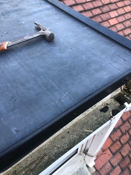 Finished EPDM with black edge trim along the gutter line