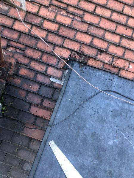 Metal trim where the new rubber roof meets the red tiles