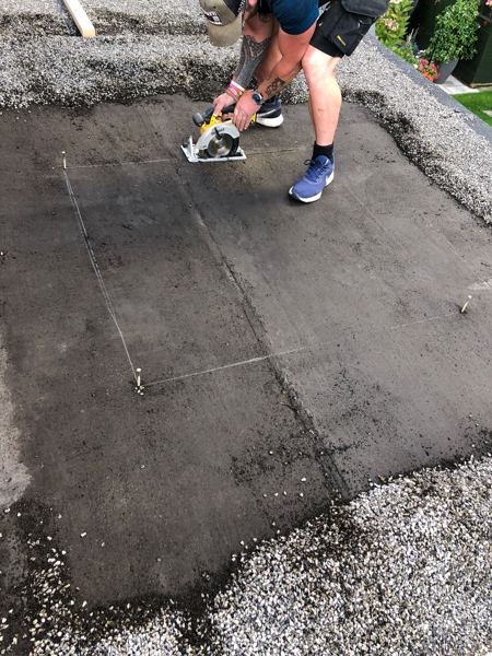 Opening marked with string lines and cut through the flat roof deck