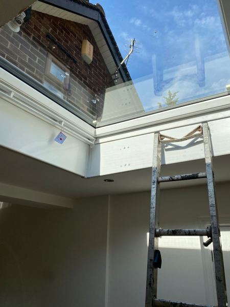 Looking up from inside through the finished skylight, reveals lined in white