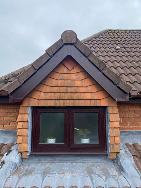 Dormer gable after, with new dark brown UPVC bargeboards under the verge tiles