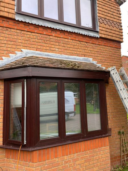Front bay window with a dark brown fascia under its tiled roof