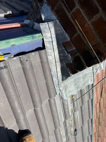New lead flashings dressed around the side of the chimney stack