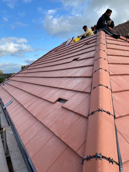New red interlocking tiles and a dry-fixed hip with clipped joints