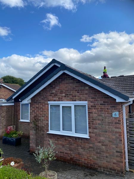 Finished front gable with new dark grey tiles and neat verges