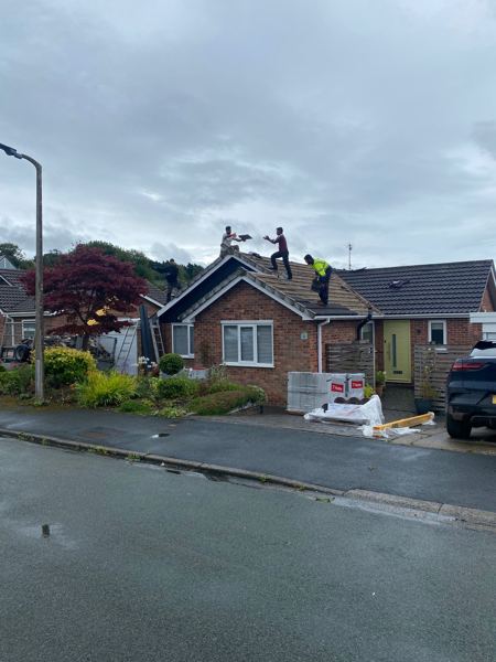 Stripping the old bungalow roof in Tarporley, seen from the road