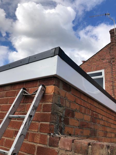 New white UPVC fascia capped with black edge trim