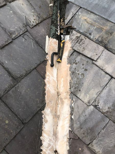Old valley lining removed, bare boards visible, roofing tool resting on top