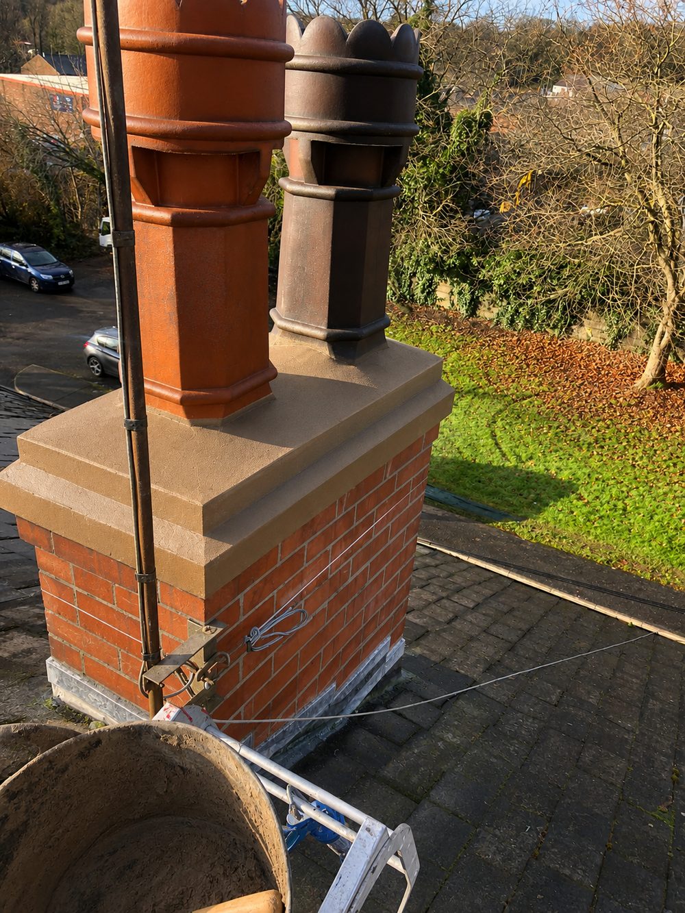 The same stack finished — repointed, a new weathered head and new lead at the base