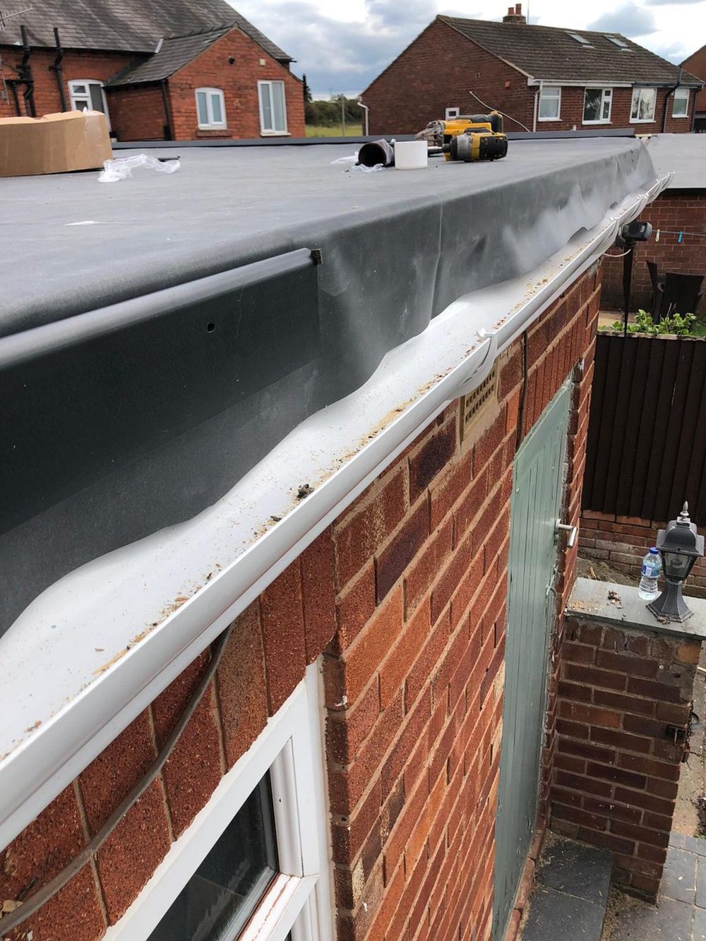 Part way along the front edge &mdash; the trim run and the covering dressed over it, the rest of the sheet still loose