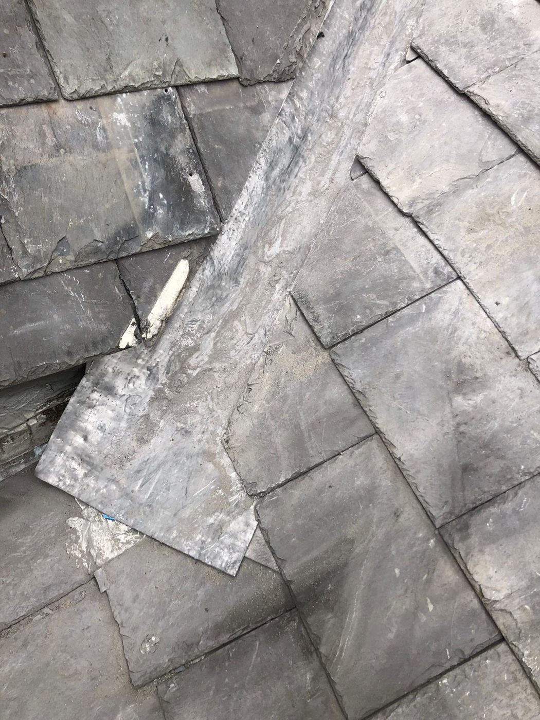 A new lead valley gutter dressed in between natural slates cut along both sides